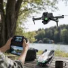 Black folding drone, silver-gray color with colorful LED light effect, gimbal camera with remote control and mobile phone stand details Picture